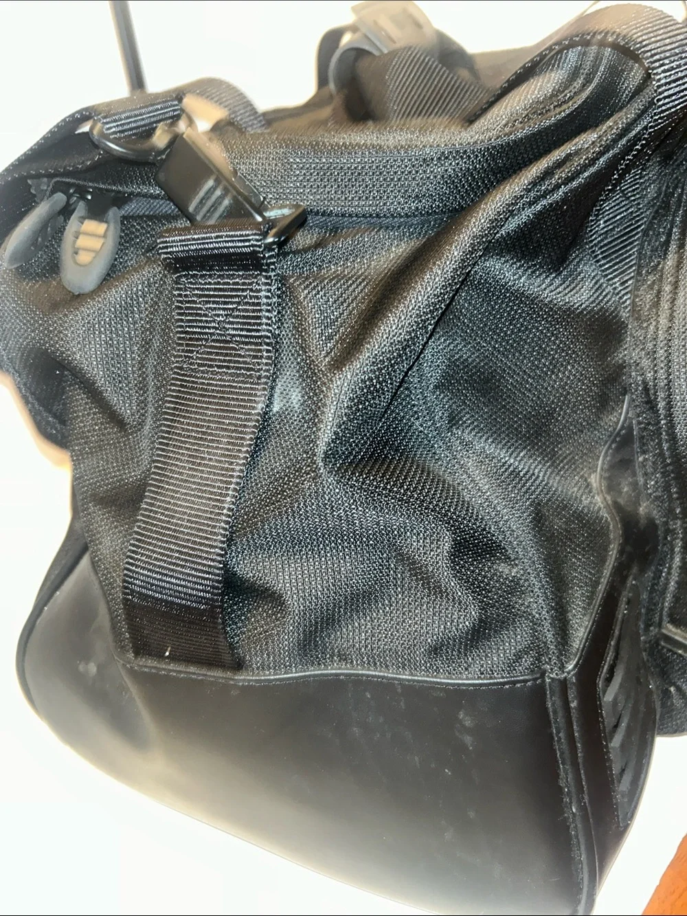 Tumi Black Duffel Bag with Red Logo Accent